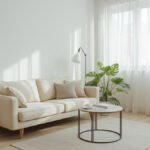 Stylish cream sofa in a small, bright living room with minimalist decor